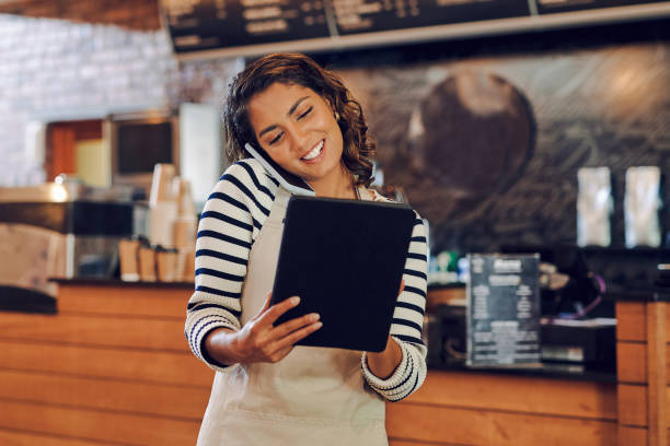 istock Shot of a young woman using a digital tablet and cellphone while working in a cafe 1397710001