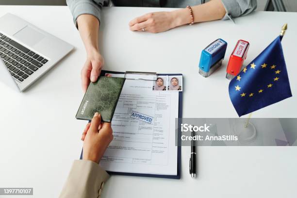 Giving Passport To Consular Officer Stock Photo - Download Image Now - Emigration and Immigration, Passport Stamp, Agreement
