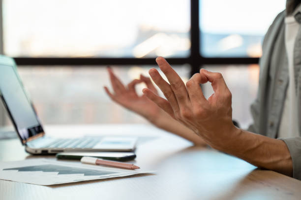 istock Employee meditates breathing deeply at workplace in office 1397710413