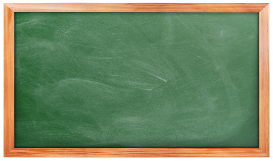 Close-up of smudged blank blackboard with board eraser and chalk.