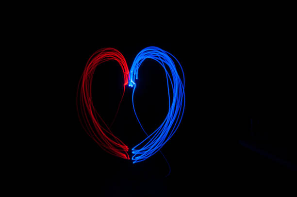 istock Red and blue color heart shape light painting 1397715157