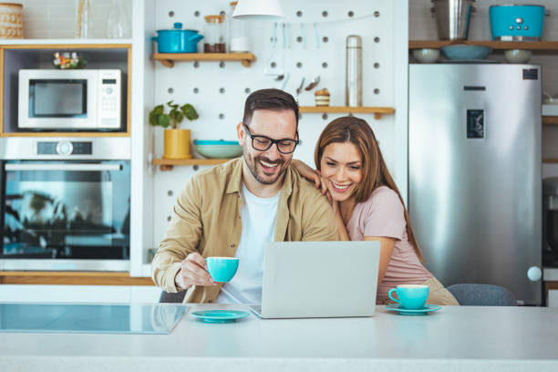 istock Happy young family couple bonding laughing using laptop 1397716099