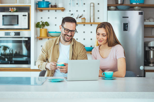 istock Happy young family couple bonding laughing using laptop 1397716105