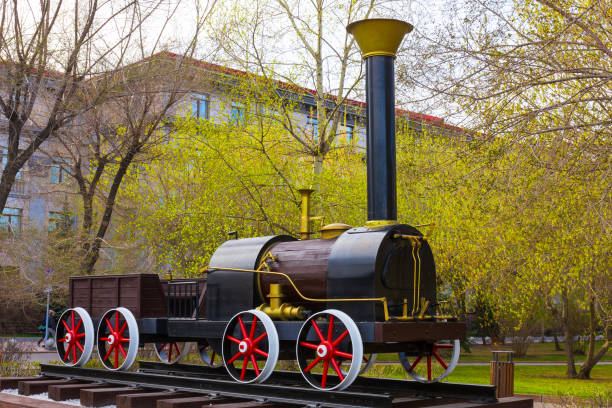 Krasnoyarsk, Russia - May 5, 2022: model of Cherepanov steam locomotive. Monument to the first steam locomotive in Russia installed near the administration building of the Krasnoyarsk railway