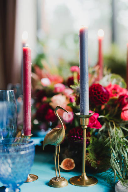 istock Table setting at the wedding reception. Floral compositions with beautiful flowers and greenery, candles, laying and plates on a decorated table. 1397718432