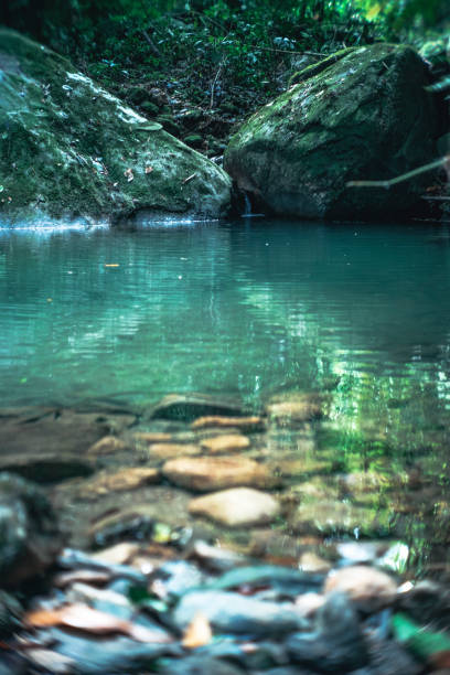 istock Blue Lake With A River Fountain And Rocks 1397718445