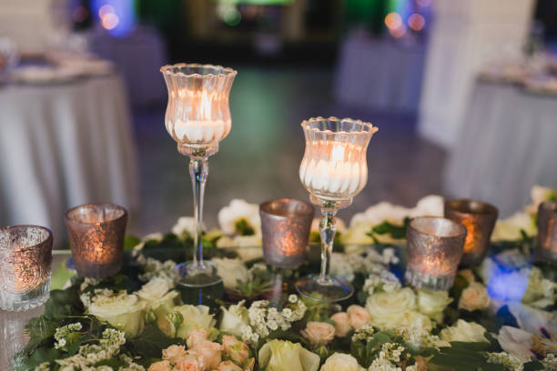 istock Table setting at the wedding reception. Floral compositions with beautiful flowers and greenery, candles, laying and plates on a decorated table. 1397719835