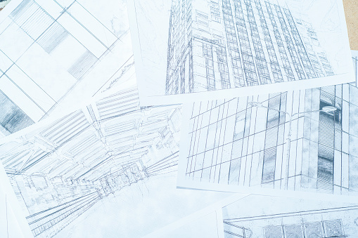 Background with architectural drawings. Sheets with sketches of modern buildings.