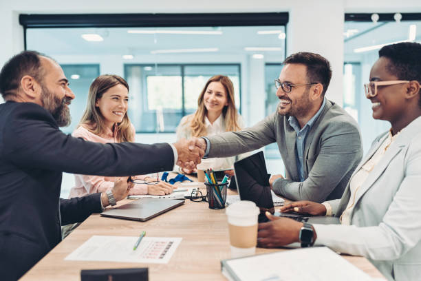 istock Businessmen shaking hands across the table 1397720240