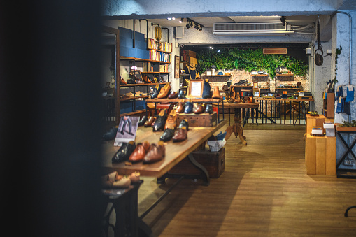 Leather shoe store display with the newest collection of elegant footwear for men. The store offers shoes, boots and accessories made from natural leather and high quality materials.
