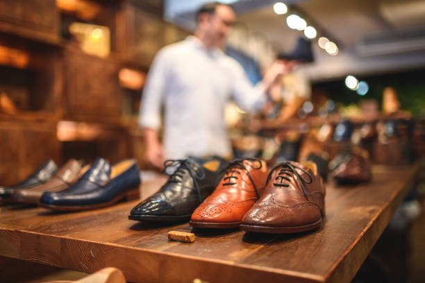 display of expensive men's brogue shoes in a luxury leather footwear store - shoe store shoe shopping retail imagens e fotografias de stock