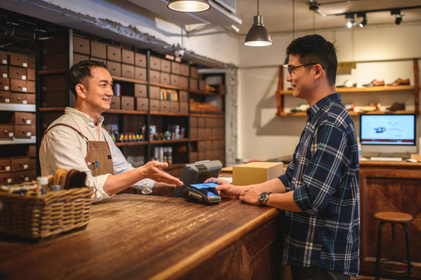 istock Young Handsome Asian Customer Doing Contactless Payment With His Digital Wallet At A Store 1397720533