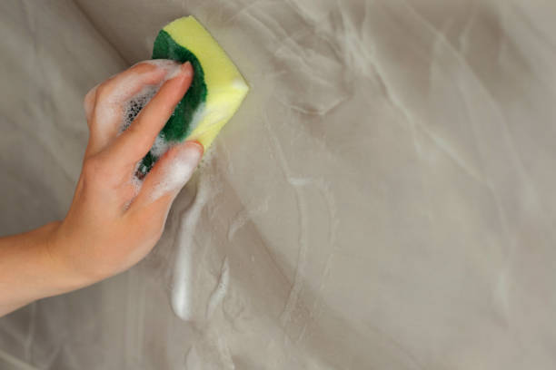 istock wipe the tiles with a cleaning sponge with foam. close-up 1397720702