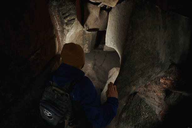 istock Person entering dark cavern in the ground 1397720969