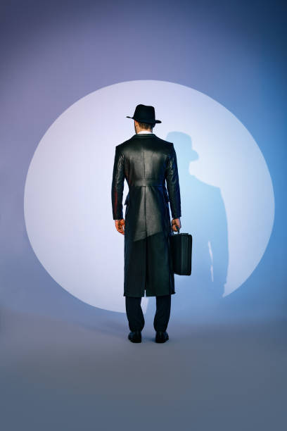 United States AI Solar System (13) - Page 11 Back-view-of-man-silhouette-in-black-coat-and-hat-holding-briefcase-in-the-spotlight-on