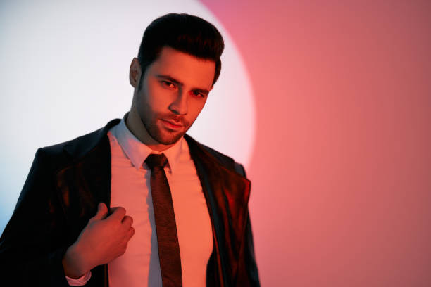 istock Handsome trendy man posing in the spotlight on studio background 1397722176