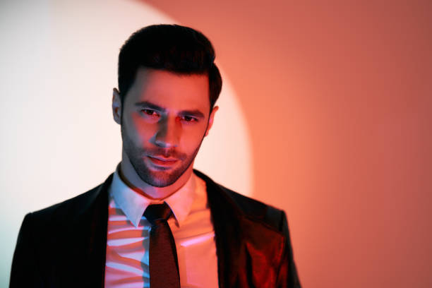 istock Handsome trendy man posing in the spotlight on studio background 1397722182