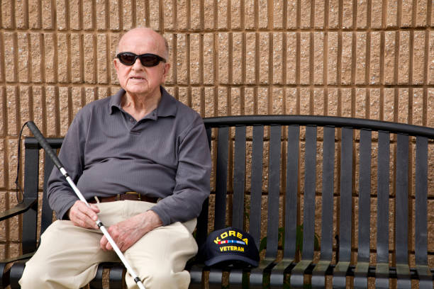 istock Blind Korean War veteran on sitting bench relaxing 1397723353