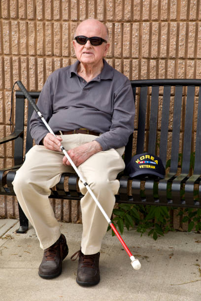 istock Blind Korean War veteran on sitting bench 1397723396
