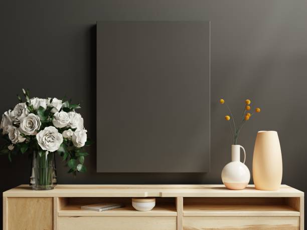 istock Black poster frame on cabinet in living room interior on empty dark wall. 1397723442