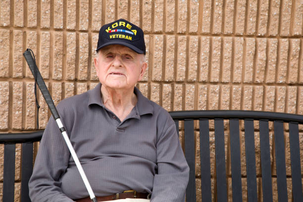 istock Blind Korean War veteran sitting on bench 1397723496
