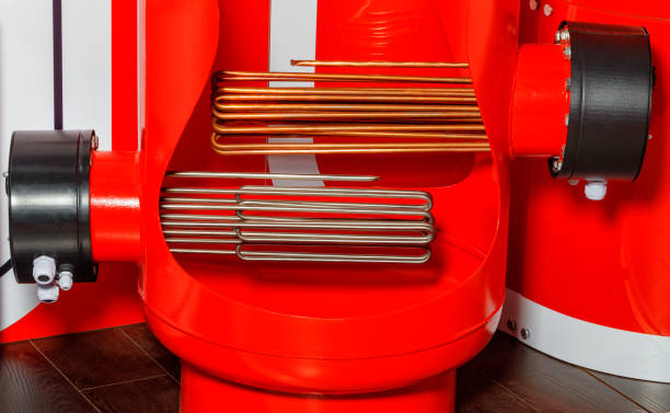 elementos de aquecimento em uma caldeira elétrica industrial em vermelho. - heating element - fotografias e filmes do acervo