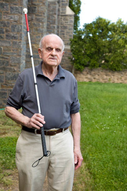 istock Blind man outdoors holding walking stick over shoulder 1397723616