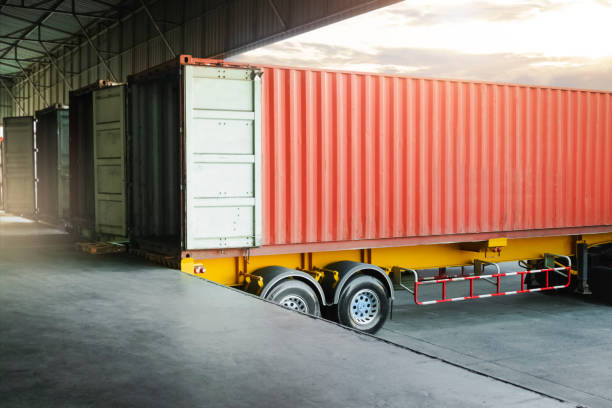 istock Cargo Container Trailer Parked Loading Dock at Distribution Warehouse. Shipping Trucks. Lorry. Cargo Freight Trucks Transport Logistics. 1397723684