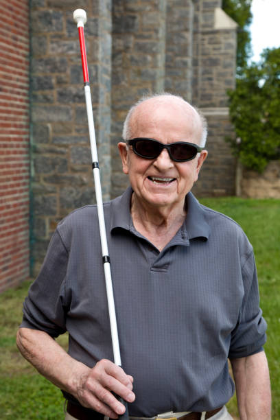 Blind man with a toothy grin and walking stick