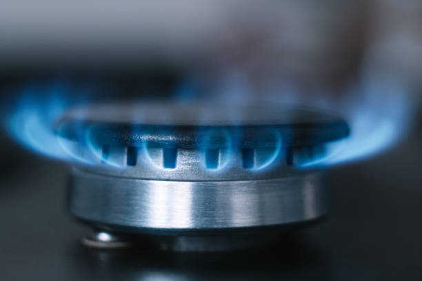 istock Kitchen burner turns on. Gas is switching on, appearing blue flame 1397726168