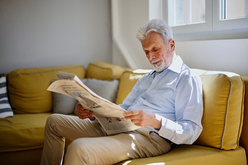 Business man reading a newspaper, cafe backgrounds.