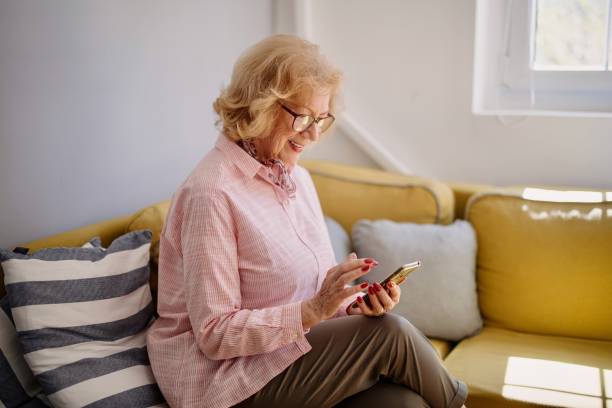 istock Smiling senior woman using her phone 1397727522