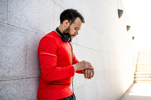 Man checking progress on smart watch after training outdoors