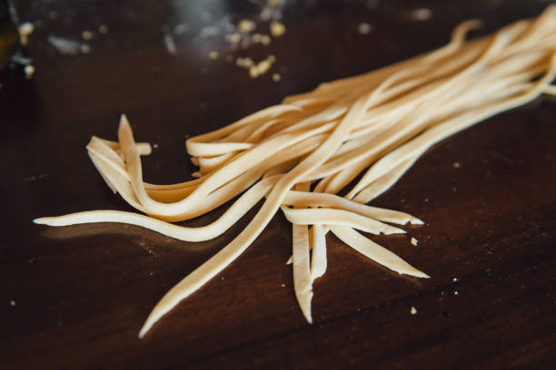 Raw traditional italian pasta fettuccine stock photo