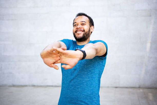 istock Happiness handsome man doing stretching exercises outdoor 1397729142