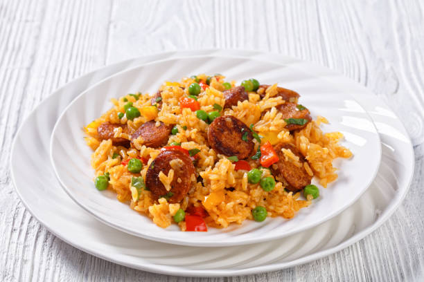 istock fried  sausages with rice and vegetables, top view 1397730577