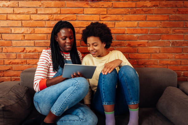 istock Black mom and teen daughter using tablet 1397731918