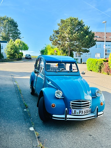 Marbach, Germany - May, 11 - 2022: Blue 2CV Citroen parked on the street under blue sky.