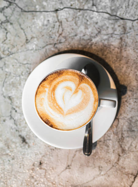 istock Cappuccino coffee close up in the making above marble table. 1397733484