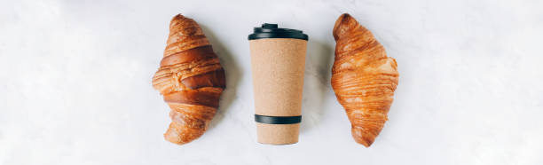 istock Croissants with coffee to go in eco cup, take away breakfast 1397733703