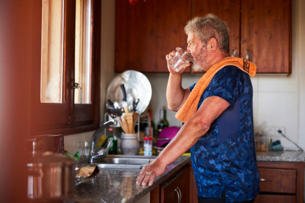 istock Senior active man drinking water in the kitchen 1397734060