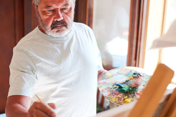 istock A retired senior man paints at home. 1397734342