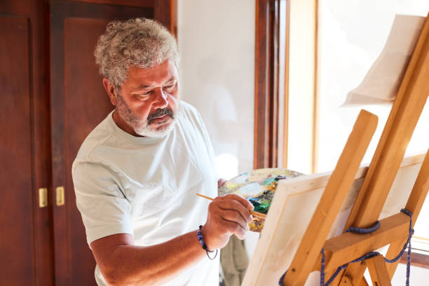istock A retired senior man paints at home. 1397734348