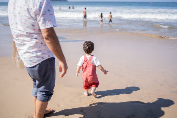 Little boy walking at the beach