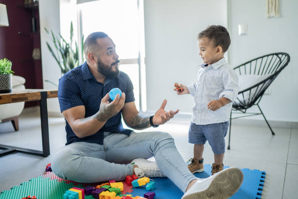 istock Father playing with son at home 1397737441