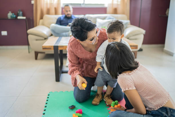 istock Mother and children playing at home 1397737527