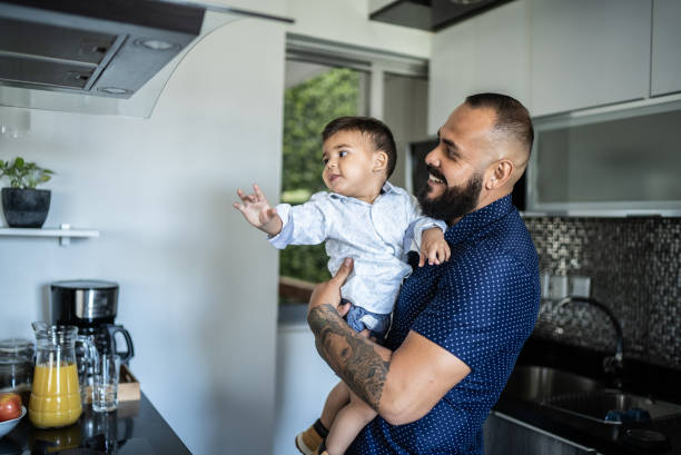 istock Father carrying son at home 1397737654