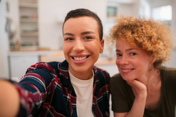 istock Happy lesbian couple taking a selfie 1397737868