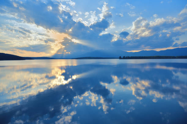 istock Beautiful Nature Background.Amazing Colorful Clouds.Water Reflections.Magic Artistic Wallpaper.Creative Photography.Blue Sky and Sunset.Mountain Landscape.Tranquil Panorama.Sun and Lake.Blue Color.Relaxation. 1397738034