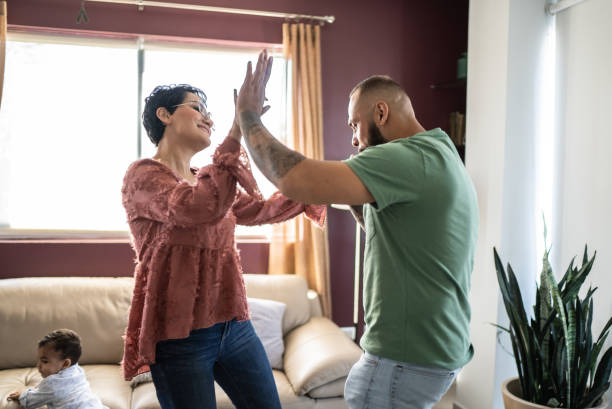 istock Mid adult couple dancing at home 1397738432